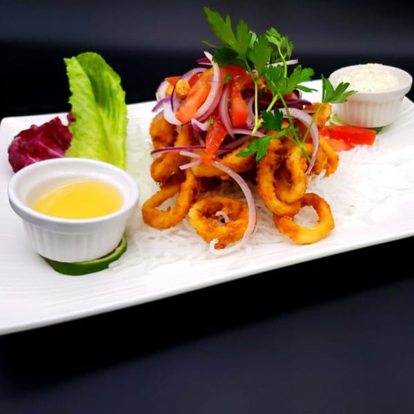 Peruvian fried calamari with red onion, tomato, and cilantro, served with two dipping sauces.